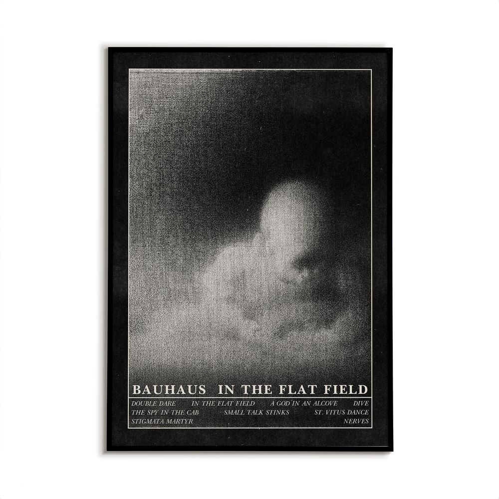 Framed black and white poster with text 'Bauhaus in the Flat Field' on a white background. Poster design features an abstract, vintage horror illustration.