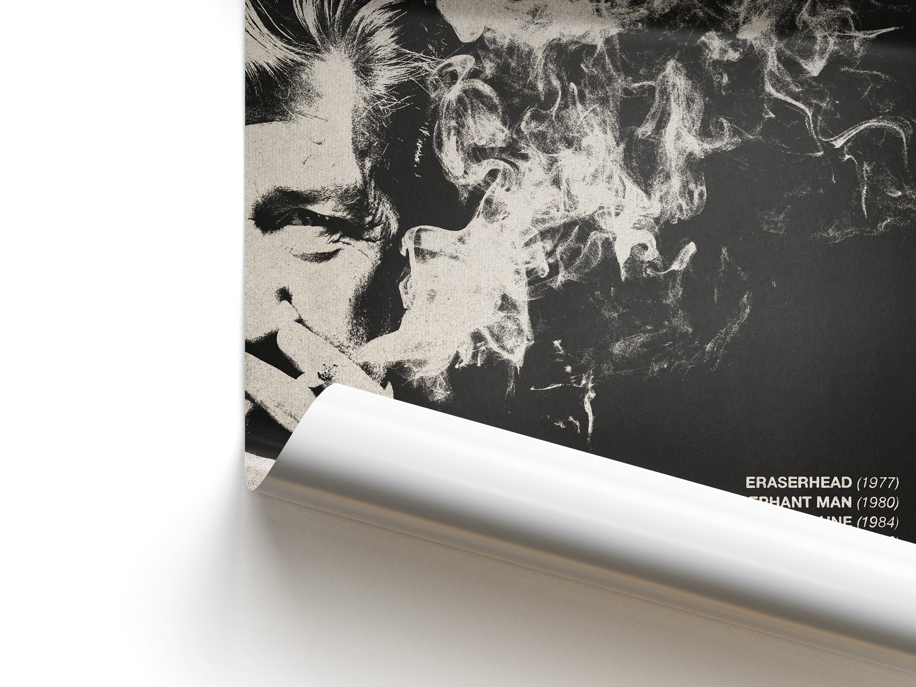 Close-up of a stylized portrait with smoke effect and Eraserhead and Elephant Man text overlay.