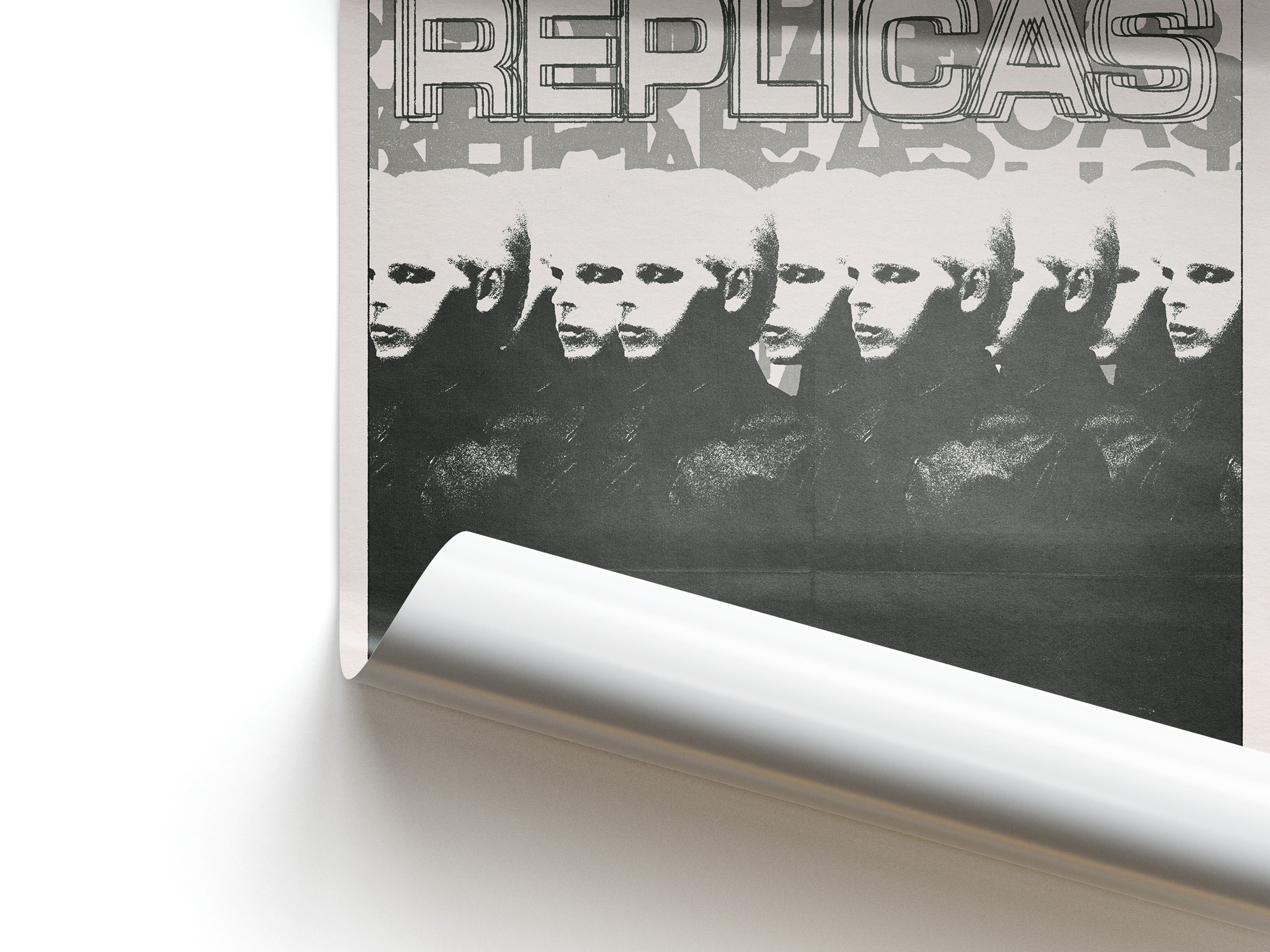 Poster with a stylized image of faces and the word 'REPLICAS' at the top.