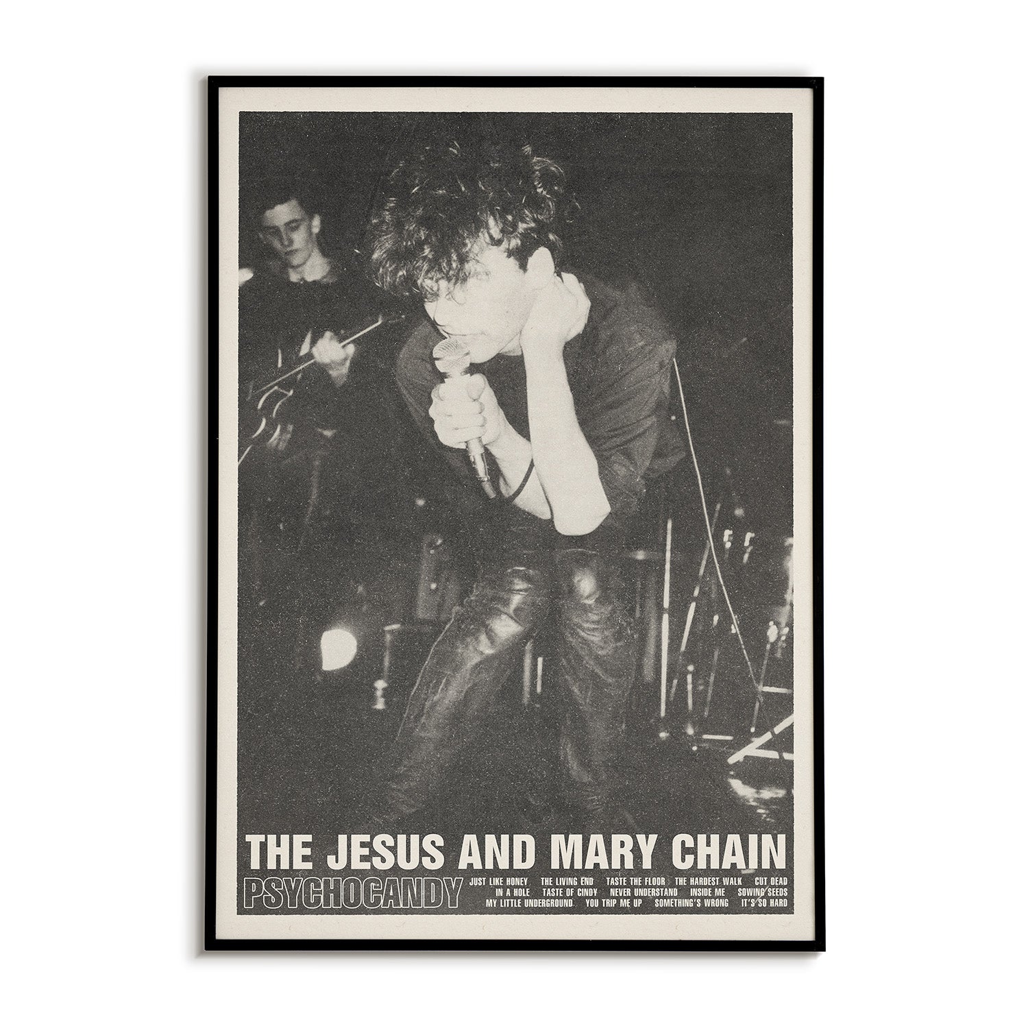 Framed poster of The Jesus and Mary Chain performing with text at the bottom.