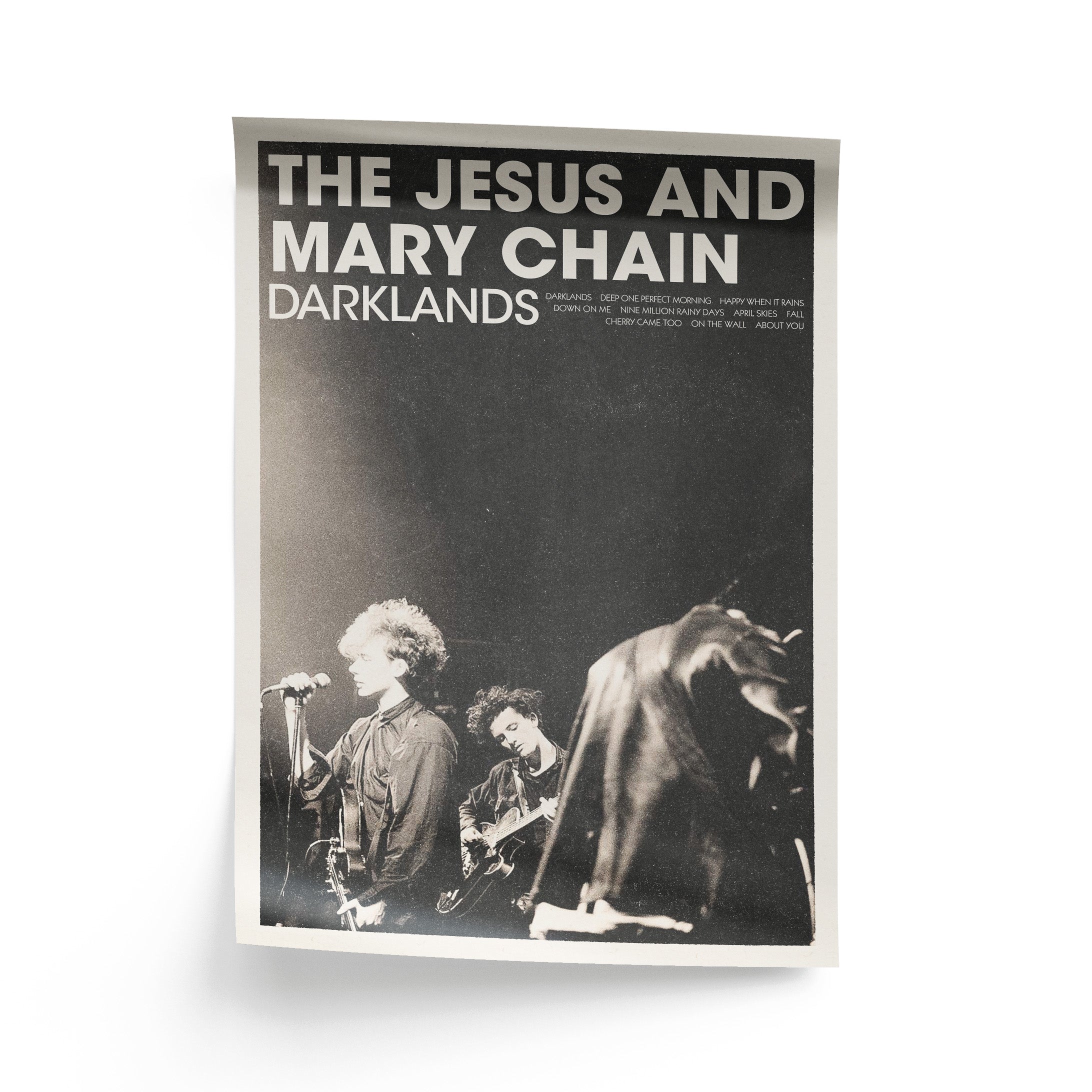 Poster of The Jesus and Mary Chain with band members on stage. Featuring the title 'Darklands' alongside the album's tracklist.