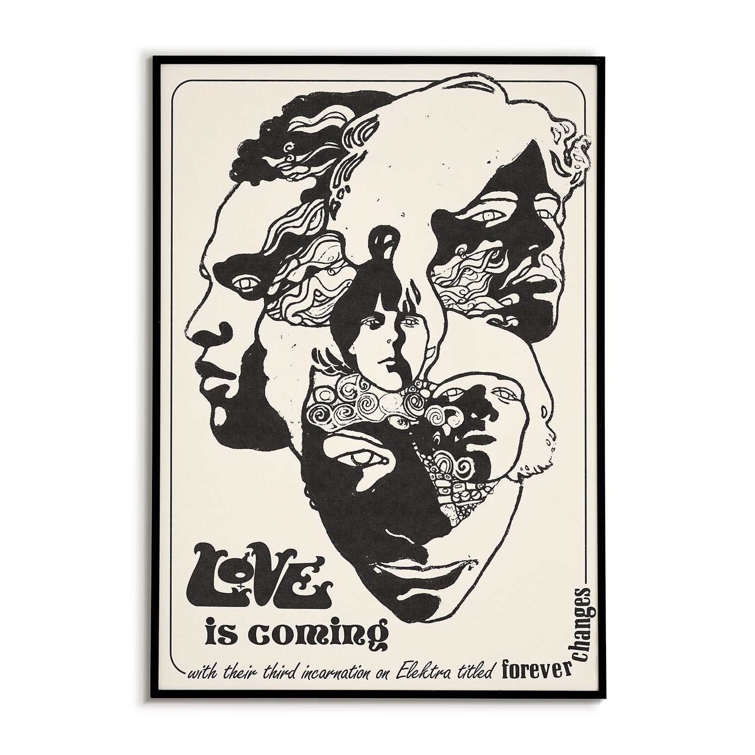 Framed artwork with stylized faces and text 'Love is coming' on a white background