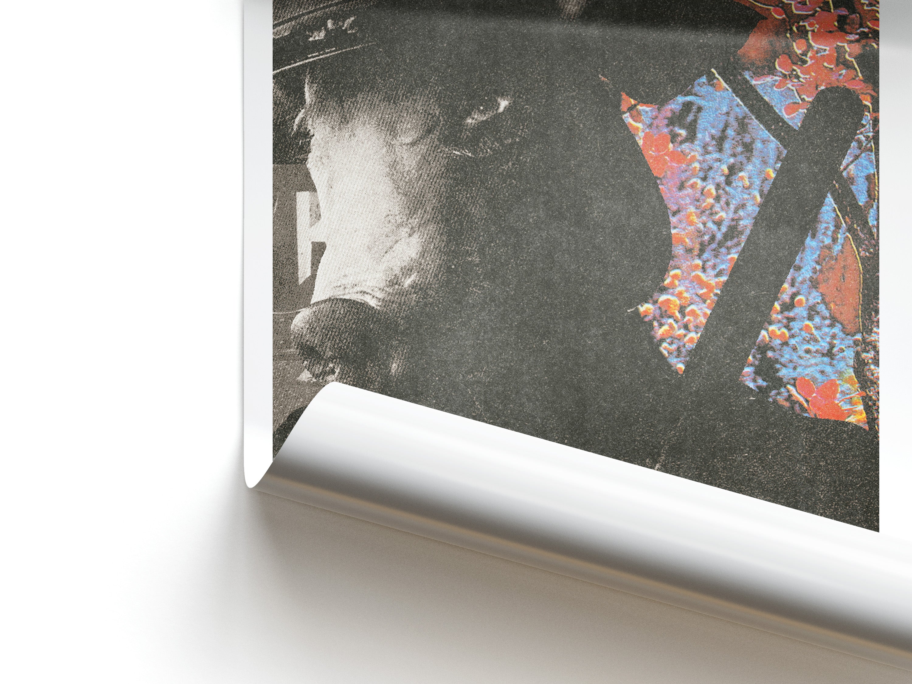 Close-up of a framed artwork with a black and white portrait and colorful abstract elements.