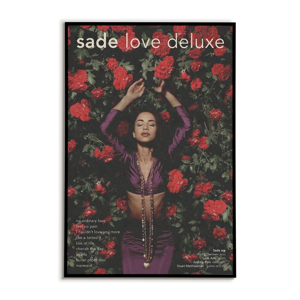 Magazine cover with a woman surrounded by red flowers and 'sade love deluxe' branding.