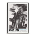 Framed poster of Sun Ra with a stylized face and text at the bottom.