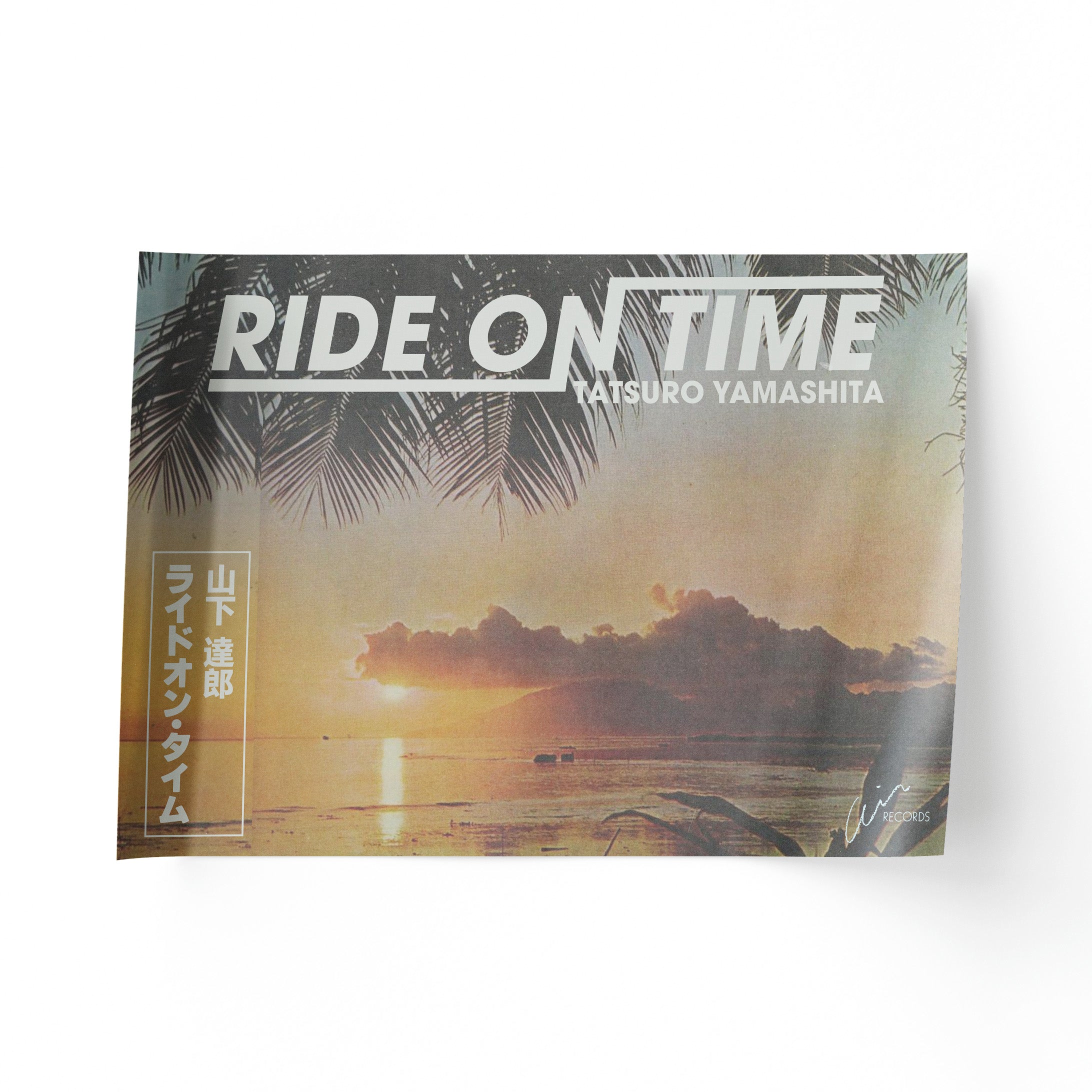 Album cover with sunset scene and palm trees, featuring the text 'Ride on Time' by Tatsuro Yamashita.