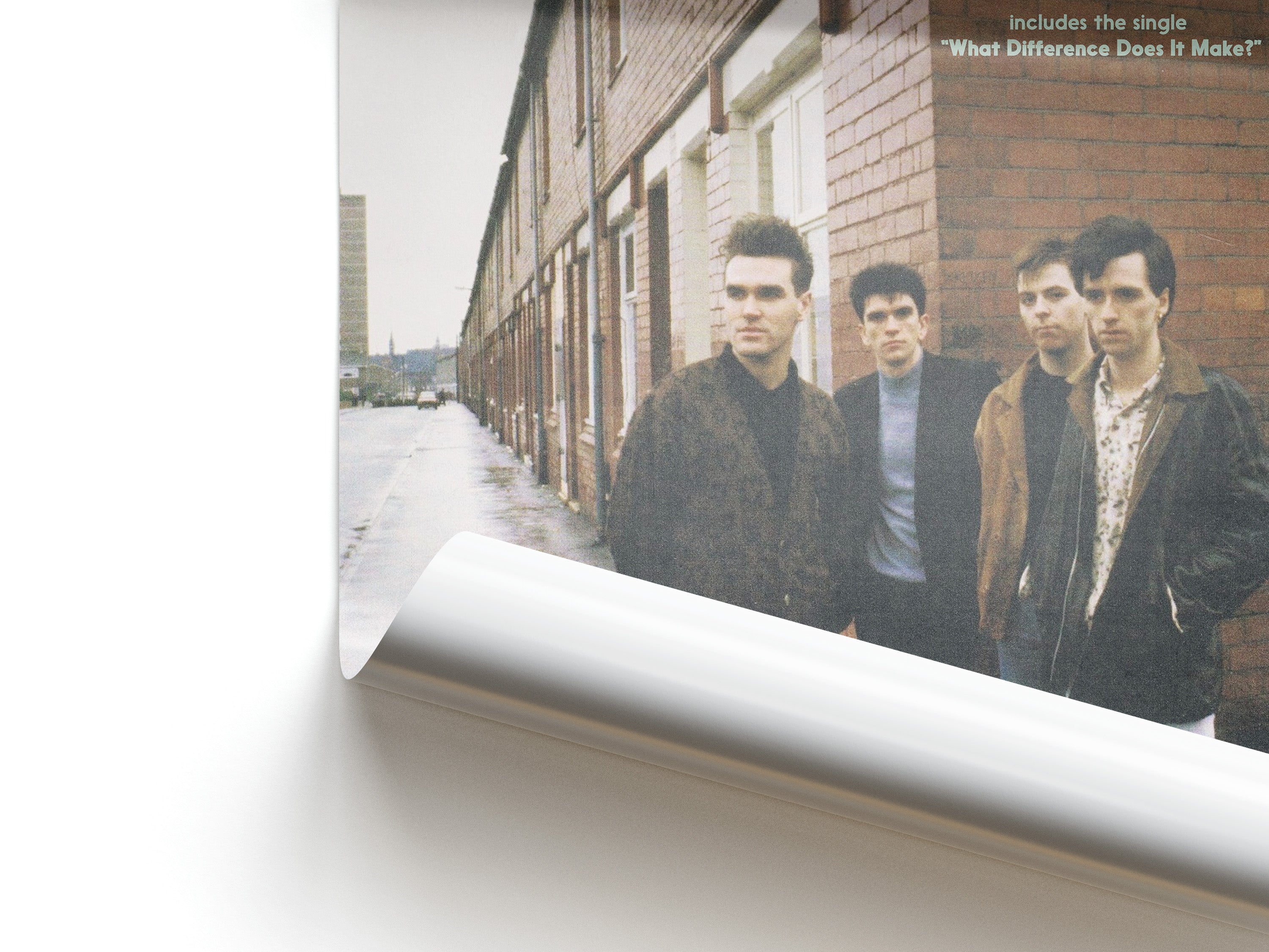Album cover with four men standing on a street, featuring text about a single.